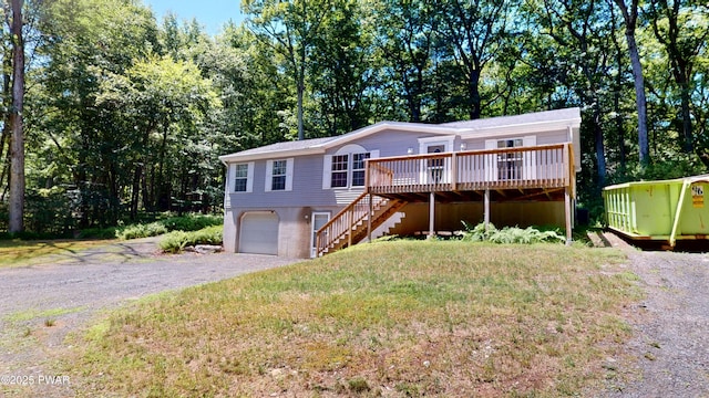 103 Windwards Ln, Dingmans Ferry, PA 18328 - view of front of home featuring stairway, gravel driveway, a deck, and an attached garage