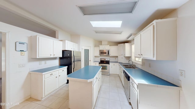 103 Windwards Ln, Dingmans Ferry, PA 18328 - kitchen with stainless steel appliances, vaulted ceiling, a center island, white cabinetry, and light tile patterned floors