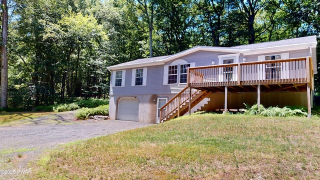 103 Windwards Ln, Dingmans Ferry, PA 18328 - view of front of property featuring stairs, a wooden deck, gravel driveway, and an attached garage