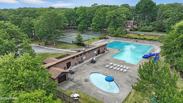 view of pool featuring tennis court