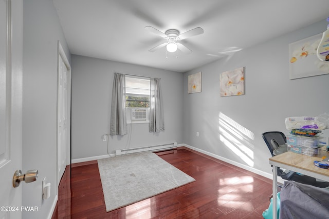 office with baseboard heating, ceiling fan, and dark wood-type flooring