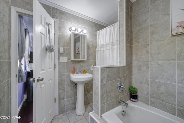 bathroom with tile patterned floors, crown molding, tile walls, and shower / tub combo with curtain