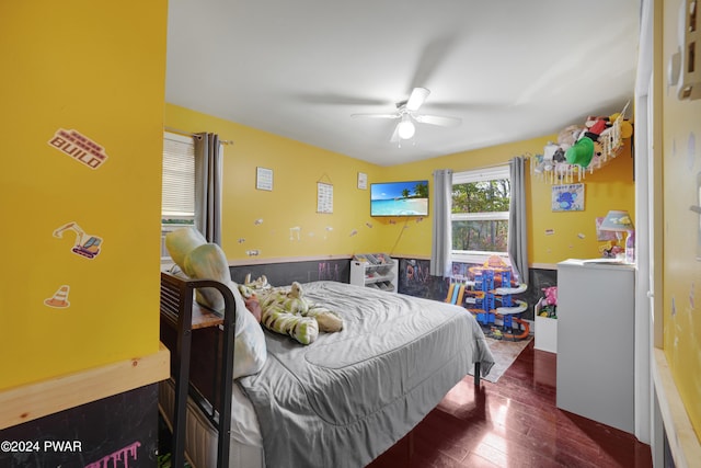 bedroom with ceiling fan and dark hardwood / wood-style flooring