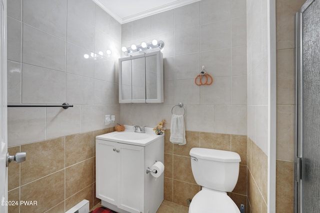 bathroom with vanity, crown molding, tile walls, toilet, and a shower with shower door