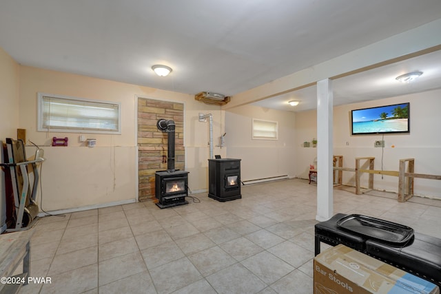 exercise area featuring a wood stove and baseboard heating