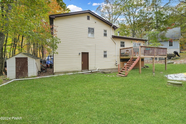 back of house with a yard, a storage shed, and a wooden deck