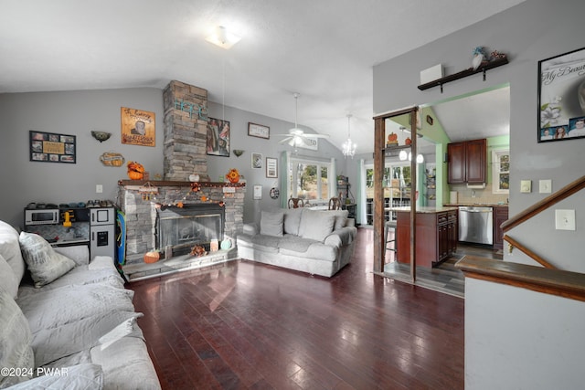 living room featuring ceiling fan, dark hardwood / wood-style flooring, a stone fireplace, and lofted ceiling