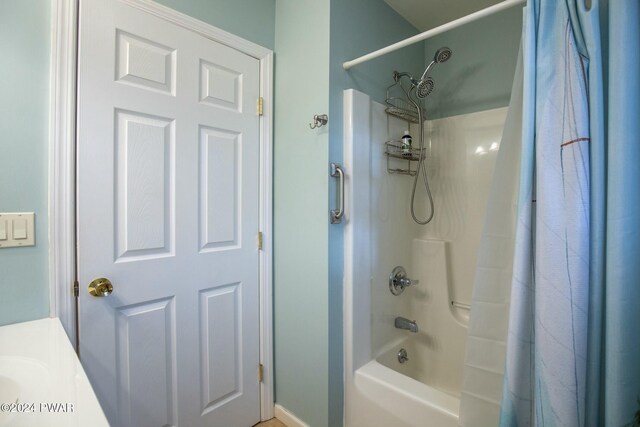 bathroom featuring shower / bath combo and vanity