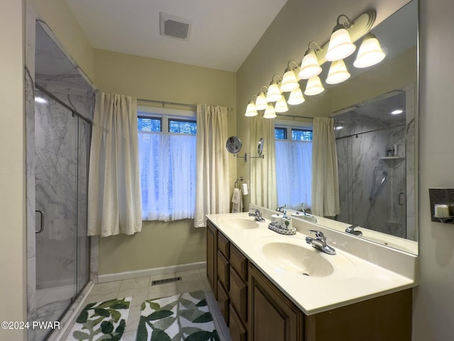 bathroom with tile patterned floors, vanity, and an enclosed shower