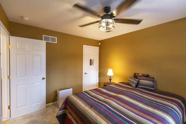 bedroom with ceiling fan and light carpet