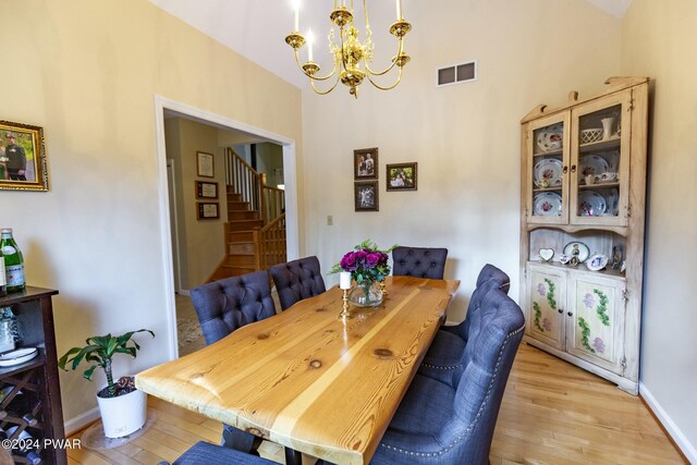 dining room featuring light wood-type flooring and an inviting chandelier