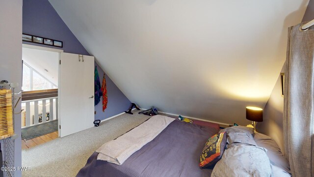 carpeted bedroom featuring vaulted ceiling