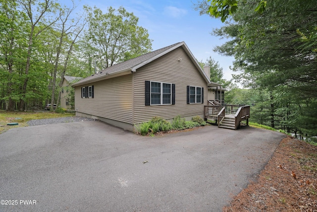 102 Circle Dr, Milford, PA 18337 - view of property exterior featuring a chimney, a wooden deck, and roof with shingles