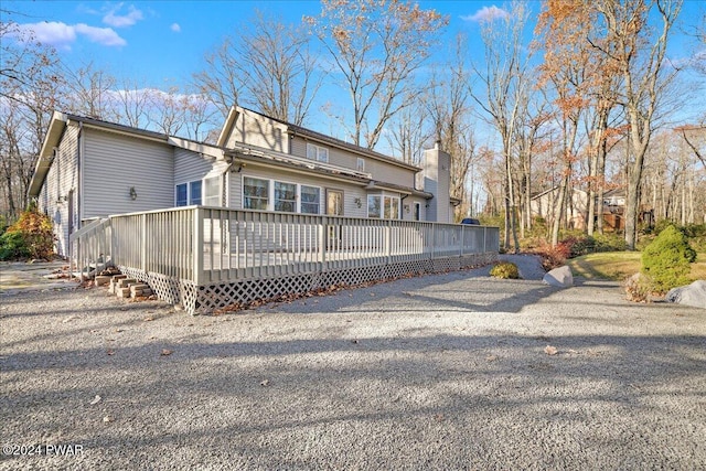 back of property featuring a deck