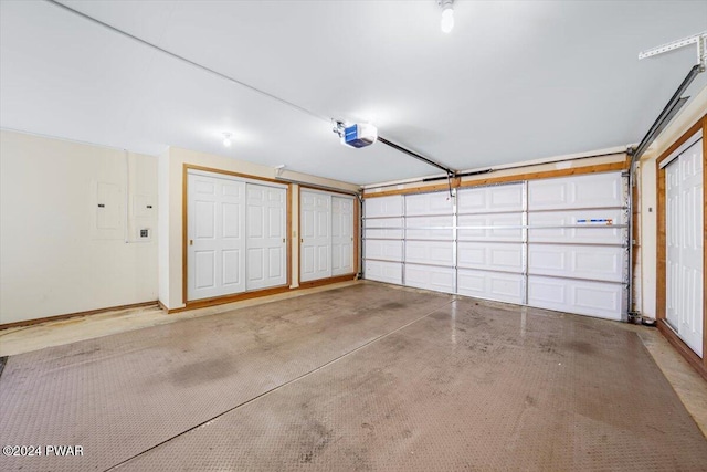 garage featuring electric panel and a garage door opener