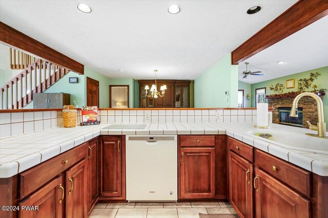 kitchen featuring ceiling fan with notable chandelier, sink, tile countertops, dishwasher, and beamed ceiling