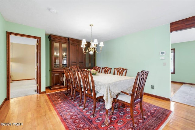 dining room featuring an inviting chandelier and light hardwood / wood-style flooring