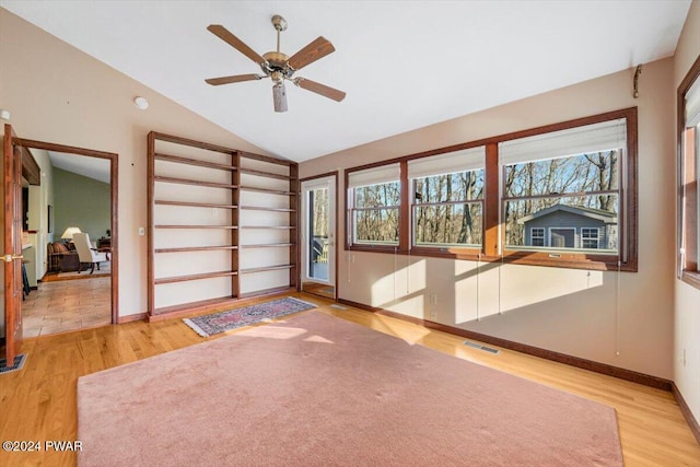 spare room with hardwood / wood-style flooring, ceiling fan, and lofted ceiling