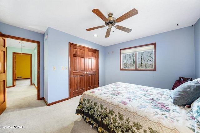 carpeted bedroom featuring a closet and ceiling fan