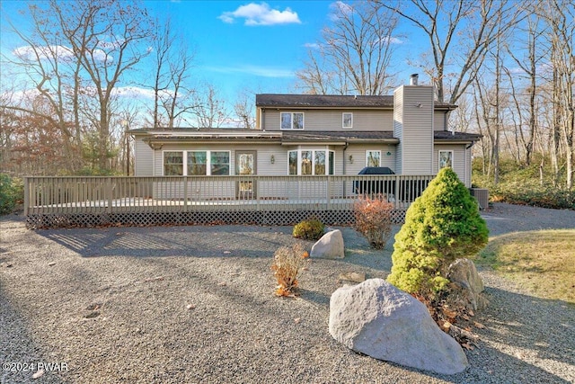 rear view of property featuring central AC and a deck