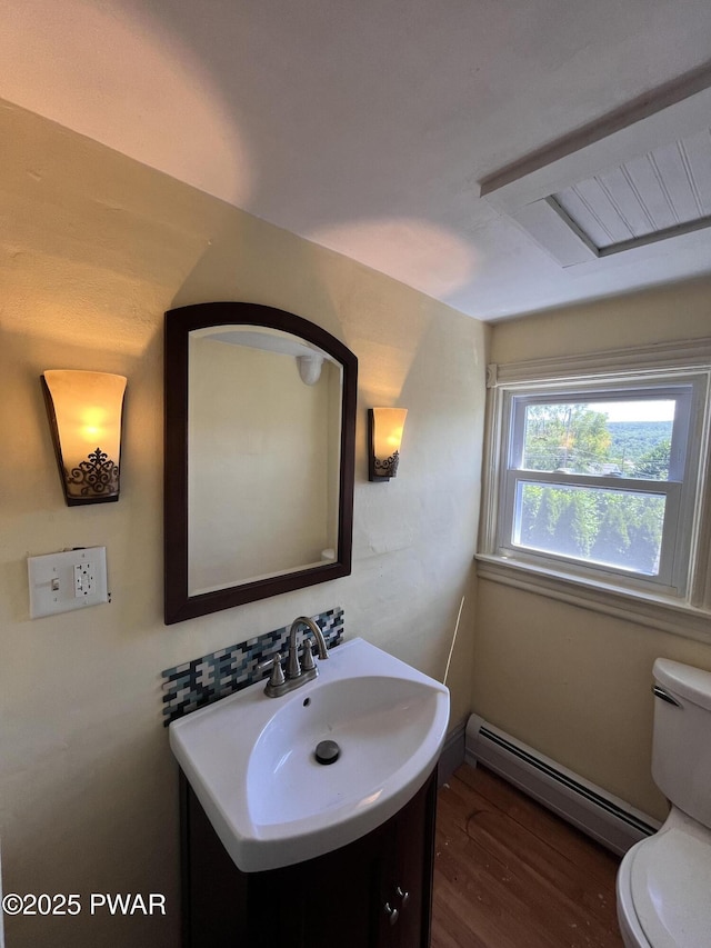 109 N St, Forest City, PA 18421 - half bathroom with a baseboard radiator, wood finished floors, and vanity