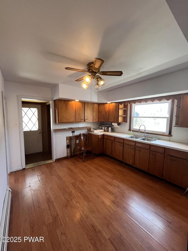 109 N St, Forest City, PA 18421 - kitchen with baseboard heating, brown cabinetry, open shelves, and hardwood / wood-style floors