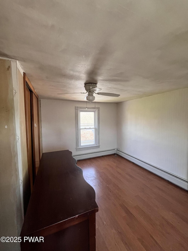 109 N St, Forest City, PA 18421 - spare room featuring a baseboard heating unit, ceiling fan, and wood finished floors