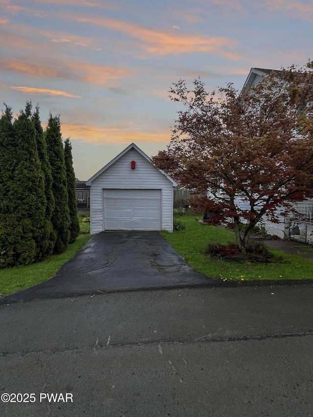 detached garage featuring aphalt driveway
