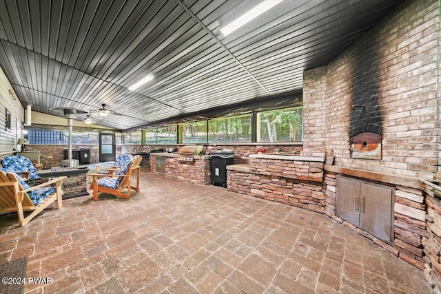 view of patio / terrace featuring an outdoor kitchen and a grill