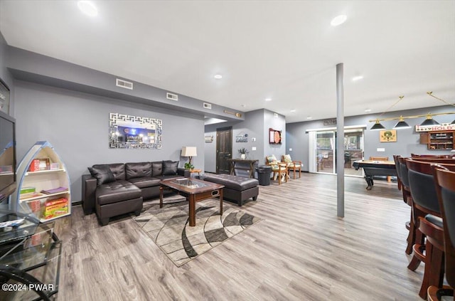 living room featuring light wood-type flooring and pool table