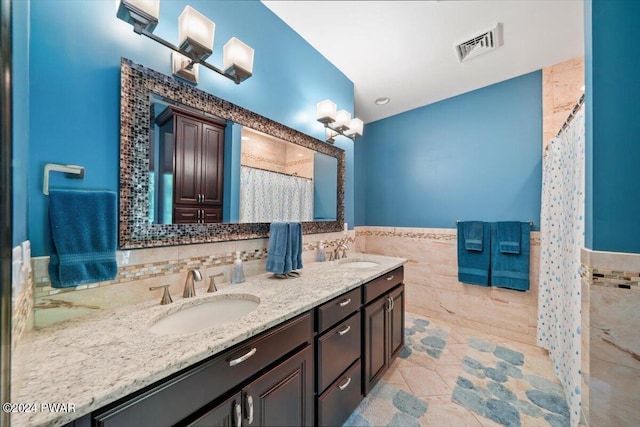 bathroom featuring tile patterned flooring, vanity, a shower with shower curtain, and tile walls