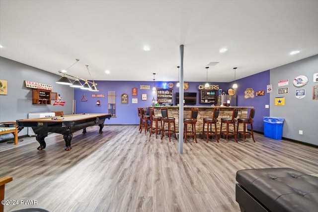 recreation room featuring wood-type flooring, indoor bar, and pool table