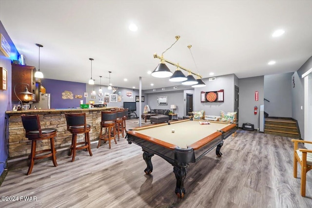 rec room with hardwood / wood-style floors, indoor bar, and pool table