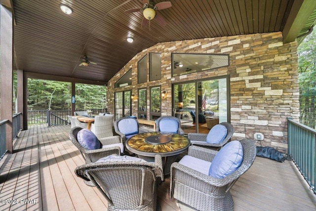 sunroom featuring lofted ceiling, ceiling fan, and a healthy amount of sunlight