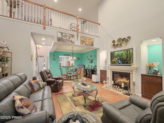 803 Macintosh Way, Matamoras, PA 18336 - living area with recessed lighting, a high ceiling, a glass covered fireplace, and light wood-style floors