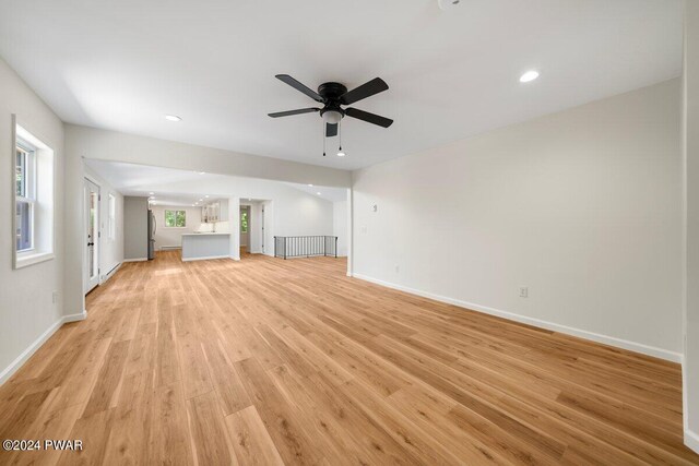 unfurnished living room featuring light hardwood / wood-style floors and ceiling fan