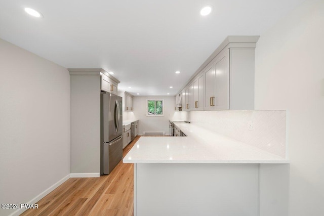 109 Widgeon Ln, Lords Valley, PA 18428 - kitchen with freestanding refrigerator, a peninsula, light wood-style floors, recessed lighting, and a baseboard heating unit