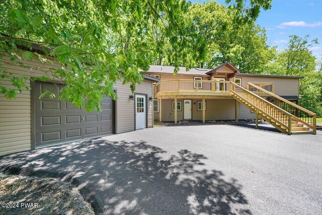 view of front facade featuring a deck and a garage