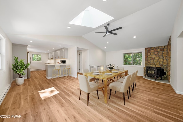 109 Widgeon Ln, Lords Valley, PA 18428 - dining room with vaulted ceiling, a baseboard radiator, plenty of natural light, a skylight, and light wood-type flooring