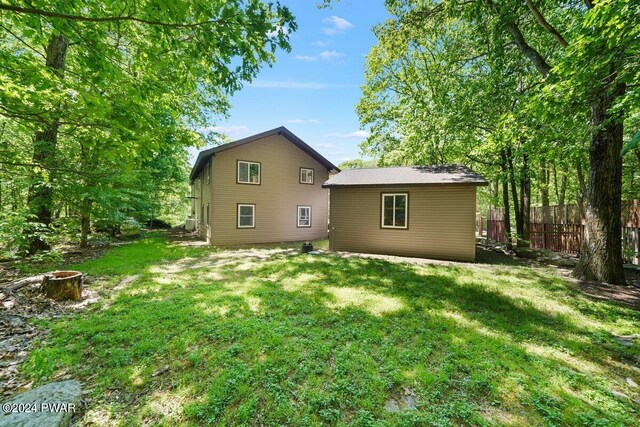 rear view of house with a yard