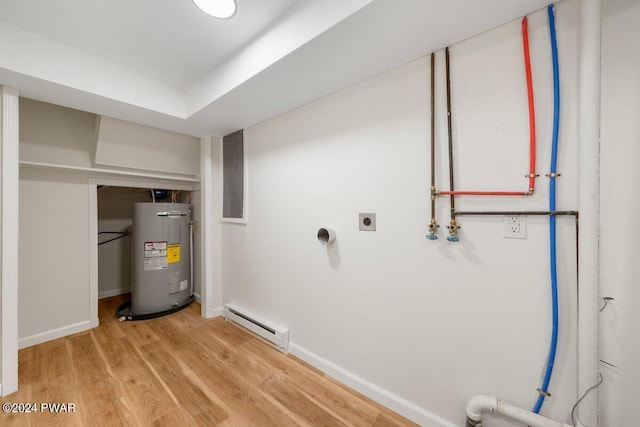 interior space with hookup for an electric dryer, wood-type flooring, baseboard heating, and water heater