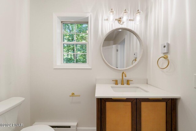 bathroom with vanity, a baseboard radiator, and toilet