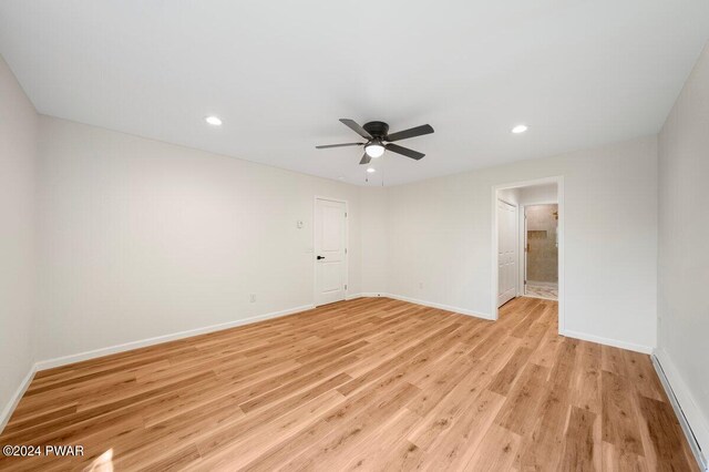 spare room with light hardwood / wood-style flooring and ceiling fan