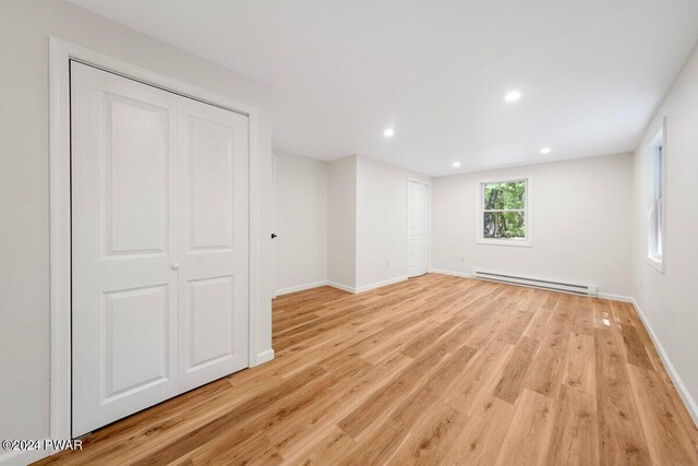 interior space featuring light hardwood / wood-style flooring and a baseboard heating unit