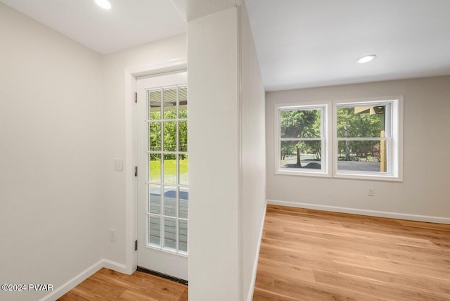 doorway to outside with light wood-type flooring