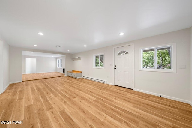 109 Widgeon Ln, Lords Valley, PA 18428 - unfurnished living room with a baseboard radiator, plenty of natural light, recessed lighting, and light wood-type flooring