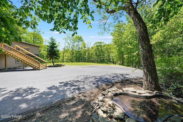 109 Widgeon Ln, Lords Valley, PA 18428 - view of yard featuring stairs, a wooden deck, and a forest view