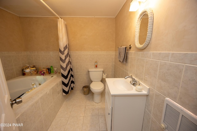 bathroom featuring tile patterned floors, vanity, toilet, and tile walls