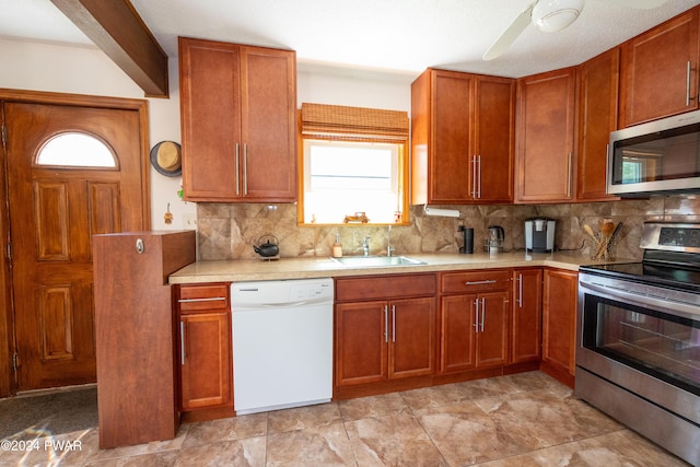 kitchen featuring tasteful backsplash, stainless steel appliances, ceiling fan, sink, and beam ceiling