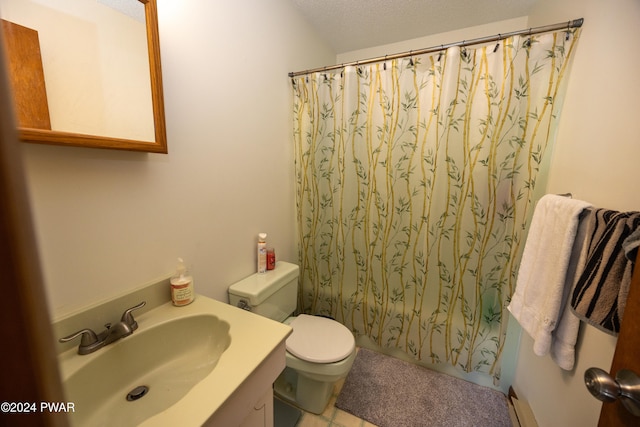 bathroom featuring tile patterned flooring, vanity, a textured ceiling, and toilet